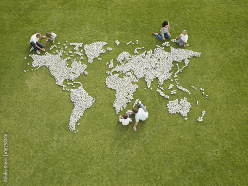 Photo: Parents and children making world map made of rocks Parents and children making world map made of rocks