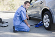 Mechanic changing car?s flat tire