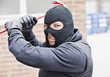 Burglar in ski mask wielding crowbar