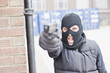 Man in skin mask holding gun