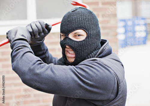 Photo: Burglar in ski mask wielding crowbar Burglar in ski mask wielding crowbar