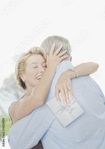 Photo: Man giving wife anniversary gift Man giving wife anniversary gift