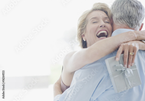 Photo: Man giving wife anniversary gift Man giving wife anniversary gift