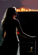 Foto: Woman walking in candlelit church Woman walking in candlelit church