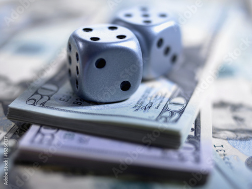 Photo: Close up of dice and US currency Close up of dice and US currency