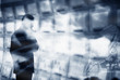 Man looking at bank of computer monitors