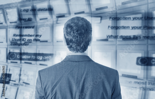Photo: Businessman with computer screen in background Businessman with computer screen in background