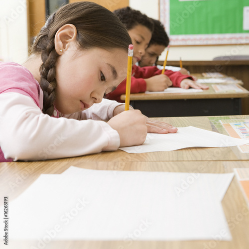 Photo: Girl doing school work in classroom Girl doing school work in classroom