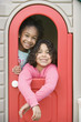 Girls inside playhouse