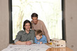 father smiling over plans