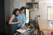 Photo: couple looking in cookbook couple looking in cookbook