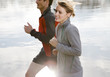 Couple jogging near pond