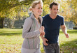 Couple jogging in park in autumn