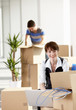 Business people unpacking boxes in office