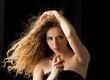 blond woman applying perfume on her body blond woman applying perfume on her body