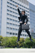 スーツ姿でジャンプする若い男性