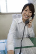 電話応対する若い女性