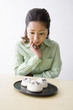 和菓子を眺めて悩む中年女性