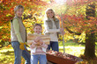 Three generation family doing yard work in autumn