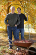 Men doing yard work together in autumn