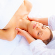 Young woman getting a facial at a spa