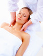 Young woman getting a facial at a spa