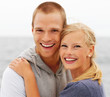 Happy young couple embracing outdoors