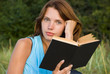young woman reading book