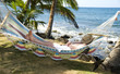 tourist asleep in hammock by the caribbean sea