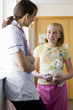 Nurse talking to girl holding stuffed animal