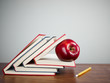 red apple on books