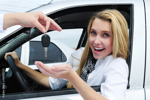 Photo: happy woman receiving car key happy woman receiving car key