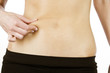 A young woman pinching her waist