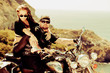 The in love pair on a motorcycle on a background of the sea