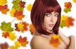 Beautiful young woman with red hair amd maple leaves