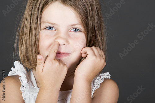 Photo: Shot of a Cute Blonde Child Picking her Nose Shot of a Cute Blonde Child Picking her Nose