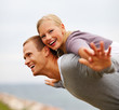Pretty woman being carried on a man's back, hands outstretched