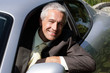 Handsome mature businessman in car