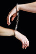 two hand shackled with handcuffs