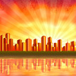Big orange city reflecting in calm water at sunset