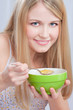 Smiled woman holding spoon and plate, preparing to eat cornflex