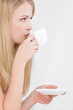 Pretty blond woman drinking cup of coffee