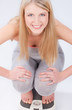 Happy blond girl on scale