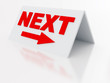 sign next with arrow on a light plastic tablet