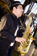 saxophonist plays outdoors at sunset