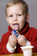 Boy eating yogurt