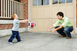 Father and son playing soccer