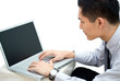 Asian business male looking at laptop