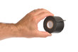 Hand holding black tape, isolated.
