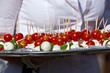 Waitress with serving platter of feta cheese, quail eggs and che